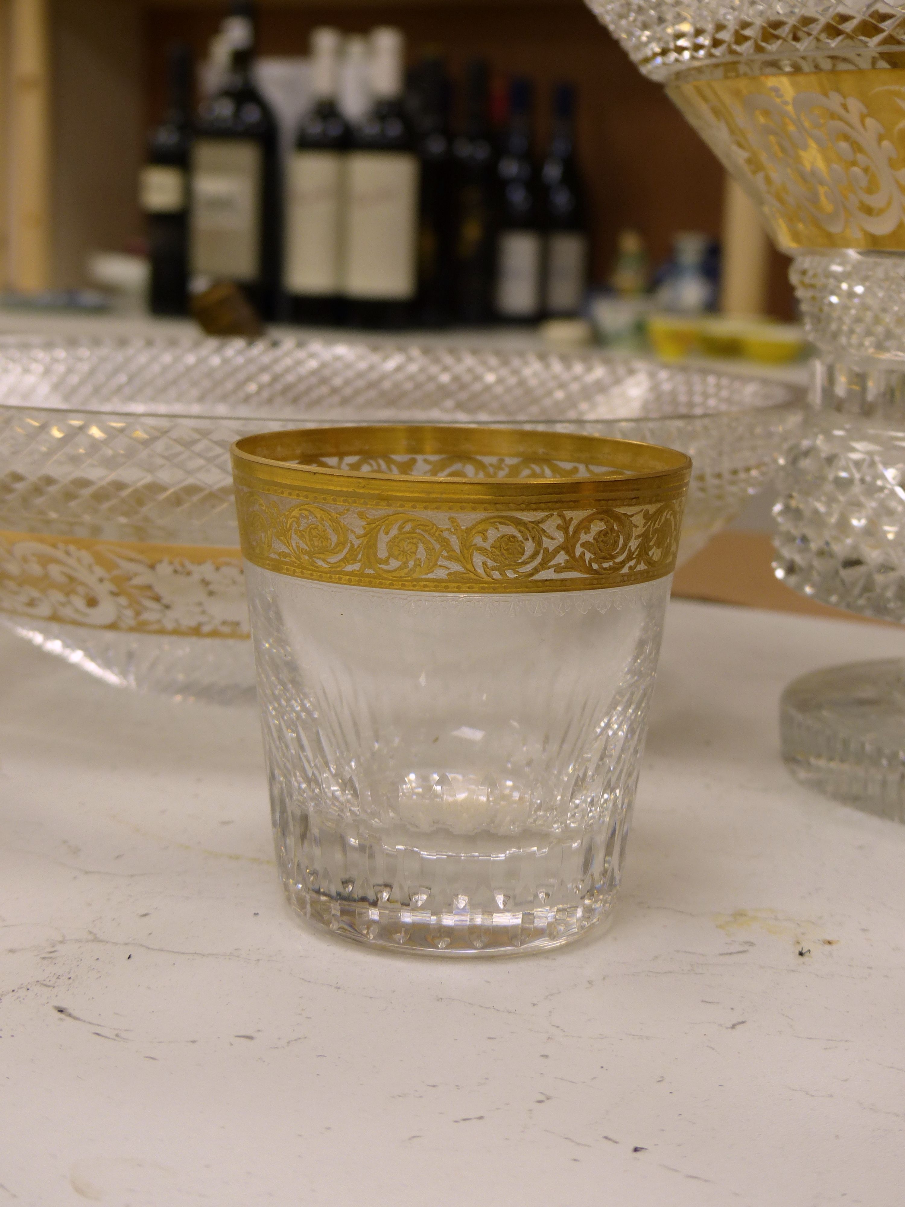 A Moser style tall tapered cut glass vase heightened in gilt, a similar circular bowl, a pedestal bowl and two St Louis tumblers